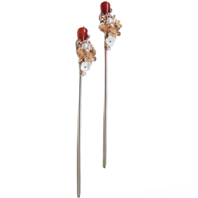 Front view of matching Luoshen vintage Chinese hair pins with slim warm-toned metal shafts, floral ornaments, white details, and red pendants
