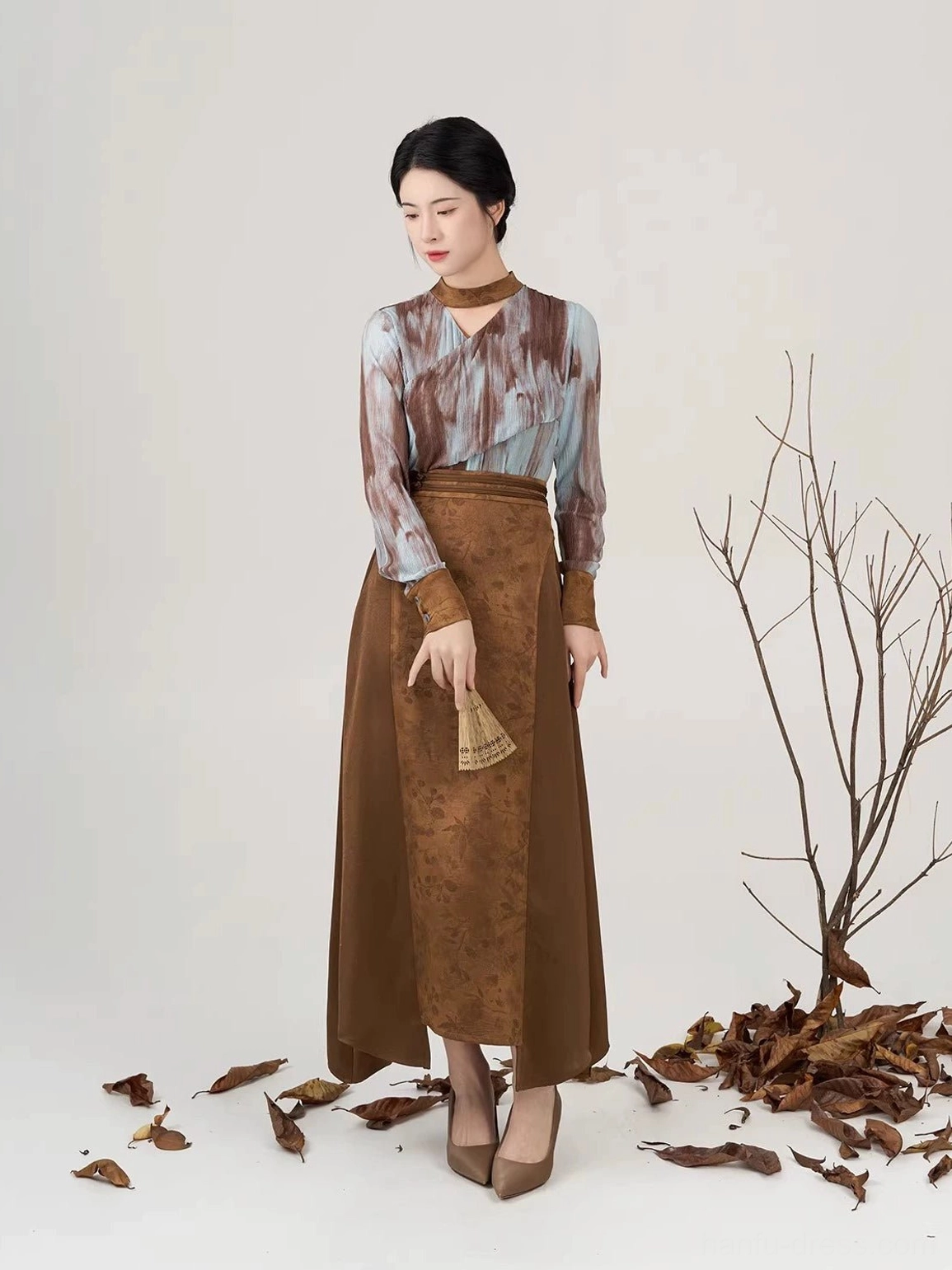 Women wearing Luotong Pass New Chinese Style outfit with long sleeve top and uneven hem Hanfu inspired skirt