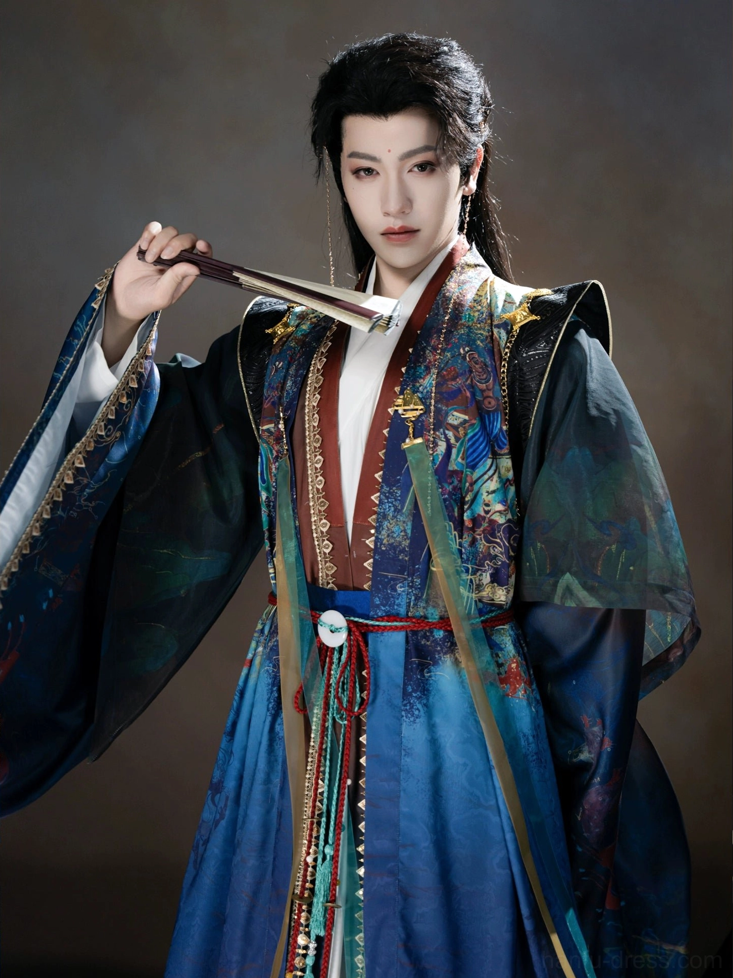 Close-up view of male Xianxia Hanfu with Dunhuang-inspired chest print, jade-look waist pendant, layered silk-style sashes, and ornate fantasy robe details