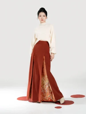 Front view of a women's maple orange modern Hanfu knit top and three-pleat skirt set with cream stand-up collar sweater and printed inner lining