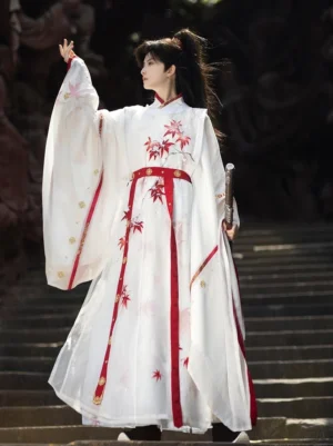 Three quarter view of Maple Snow men hanfu outer robe with wide sleeves red maple motifs and sword styling