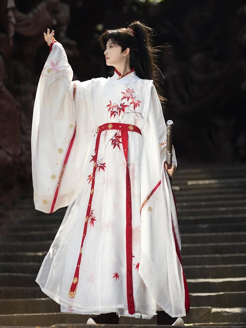 Three quarter view of Maple Snow men hanfu outer robe with wide sleeves red maple motifs and sword styling