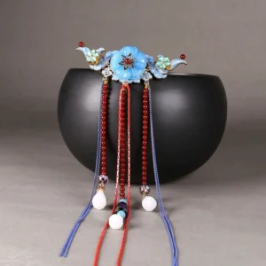 Maris traditional Chinese tassel back hair pin displayed on a black bowl, featuring blue flower ornament red and blue beads and white pendants