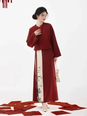 Three-quarter view of a maroon Chinese New Year Hanfu outfit with metal frog closures, matching wrap skirt, and elegant festive styling