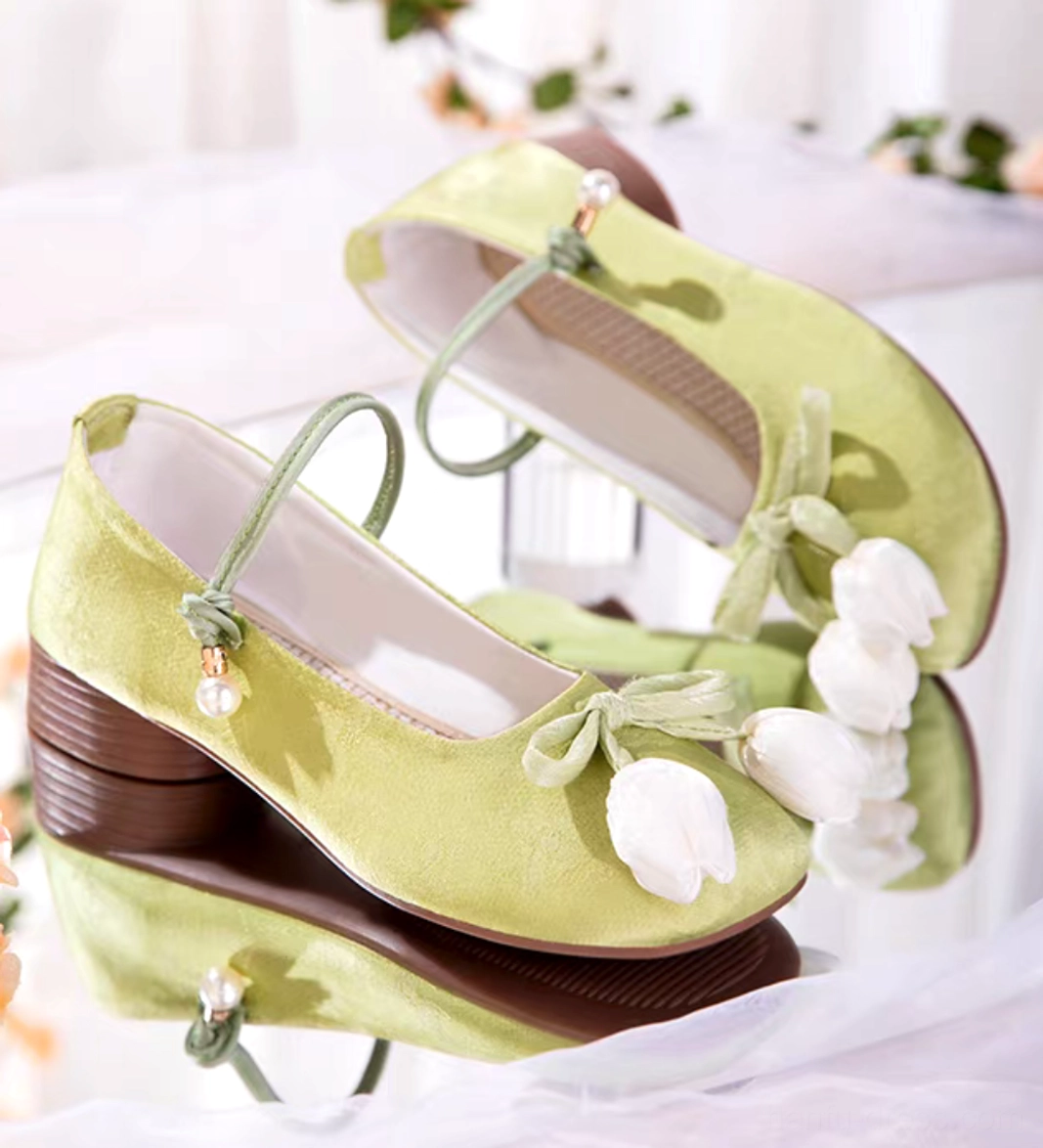 Matcha green tulip Hanfu block heel Chinese shoes with white floral bows, pearl ankle strap accents, woven insoles, and brown rubber heels