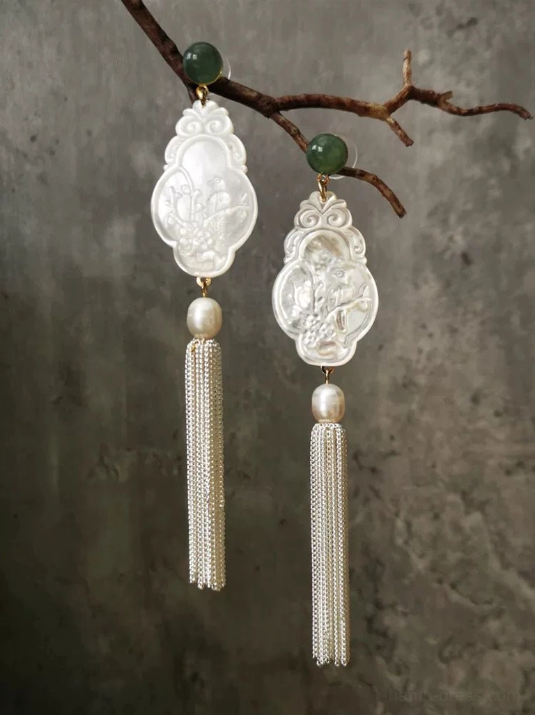Matching floral carved shell Chinese earrings with silver tassel chains, freshwater pearls, and green jade studs