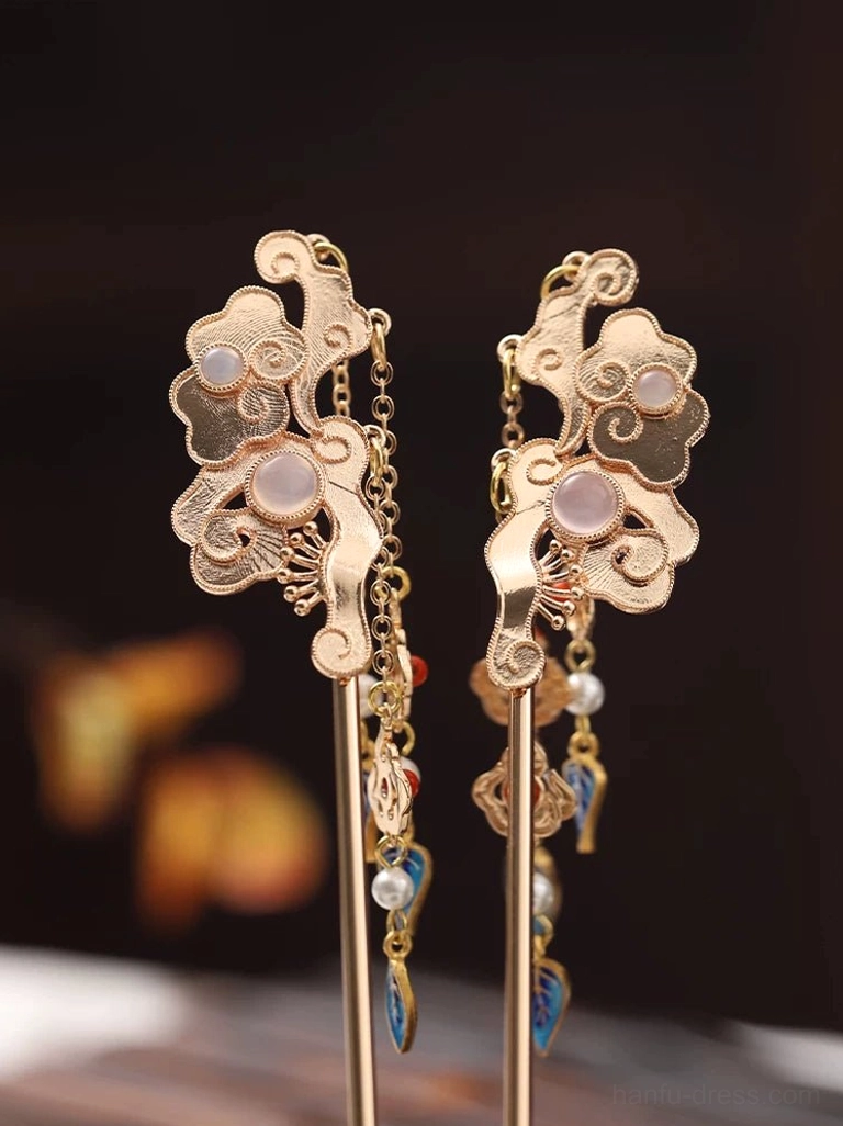 Matching pair of traditional Chinese cloud hair sticks with gold-tone carved motifs and hanging tassels decorated with red, blue, and pearl accents