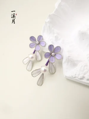 Matching pair of smoke purple Chinese flower earrings with white pearls and translucent hanging petal charms, shown in a front view for Hanfu and Qipao styling