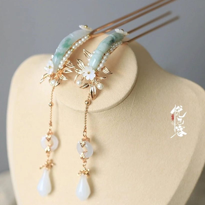 Pair of matching traditional Chinese jade hair pins with gold-toned frames white floral decorations and dangling white jade tassel pendants