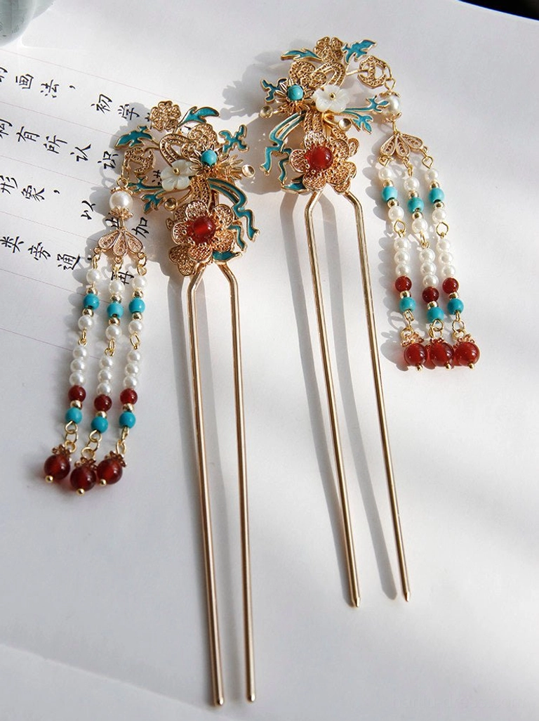 Matching pair of traditional Chinese tassel hair sticks with gold filigree floral tops blue enamel accents red beads and coordinated beaded tassels