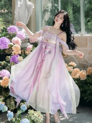 Model wearing a Meiling Sparrow Tang Dynasty inspired modern hanfu fairy slip dress with purple beige gradient chiffon skirt and embroidered floral bust in a hydrangea garden