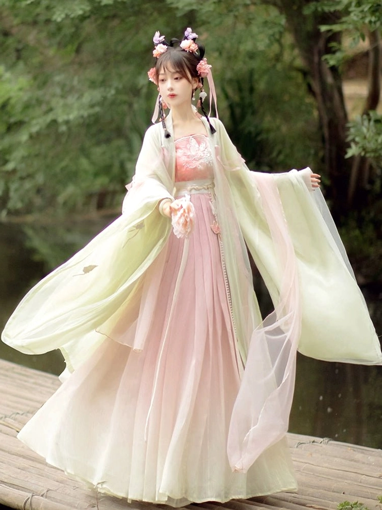 Pink and cream gradient qiyao ruqun Tang Dynasty Hanfu with sheer wide sleeves and embroidered floral chest panel by a lakeside