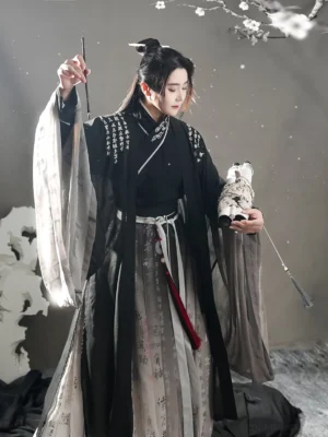 Front three-quarter view of a men's black and grey wuxia hanfu set with Chinese calligraphy prints, wide sleeves, layered robe, and Wei Jin inspired styling