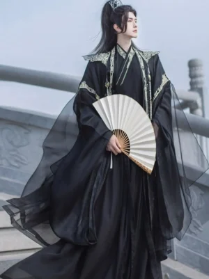 Back and side view of black xianxia hanfu for men with layered sheer outer robe, gold accents, and folding fan