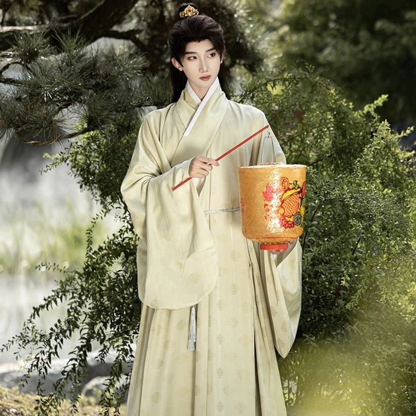 Three quarter front view of cream beige men’s Ming Dynasty Hanfu inner robe with tonal woven jacquard pattern and wide sleeves