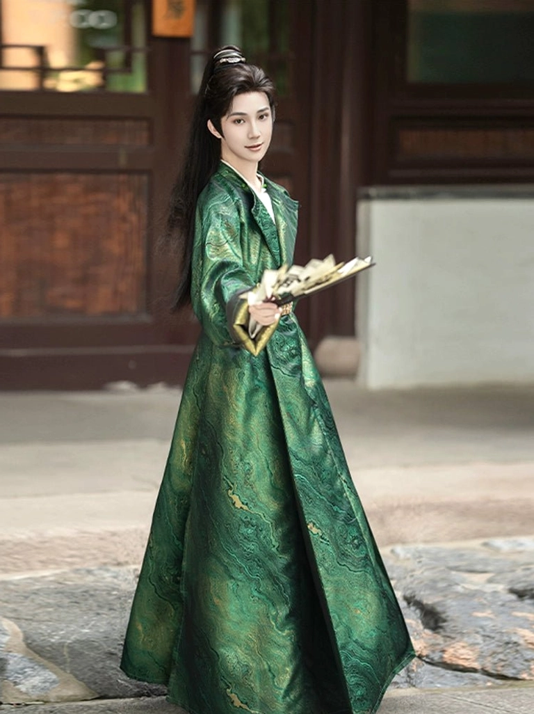 Side view of a man wearing a dark green men's Tang-style Hanfu robe with water-wave jacquard fabric and gold round waist belt at a traditional Chinese courtyard