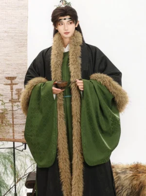 Men's Hanfu robe and fur-trimmed outer coat shown from the front with dark green jacquard fabric, blue waist sash, tassel detail, and traditional Chinese styling