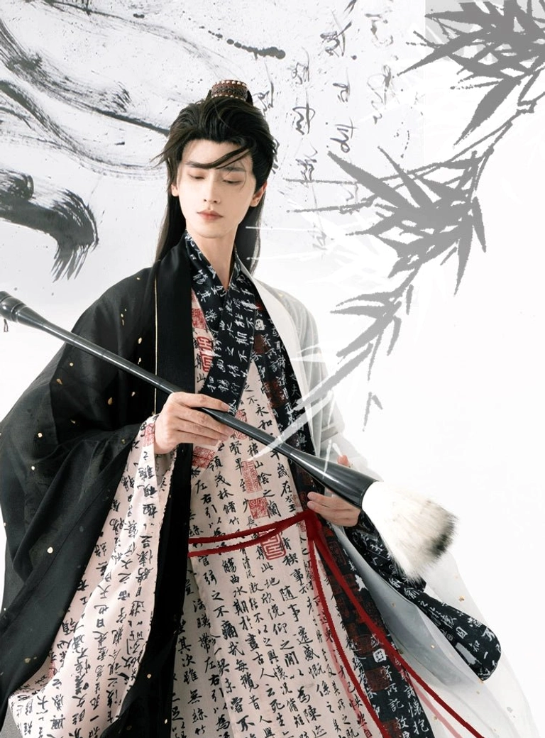 Close-up of men's Ming inspired calligraphy hanfu robe featuring layered black and ivory fabric, cursive Chinese script, and red waist sash styling