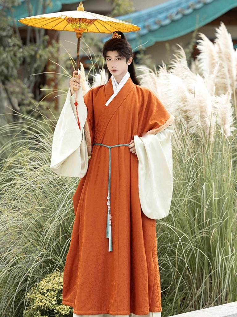 Men’s burnt orange Ming Dynasty Hanfu outer robe layered over cream inner robe with tassel belt and oil paper umbrella