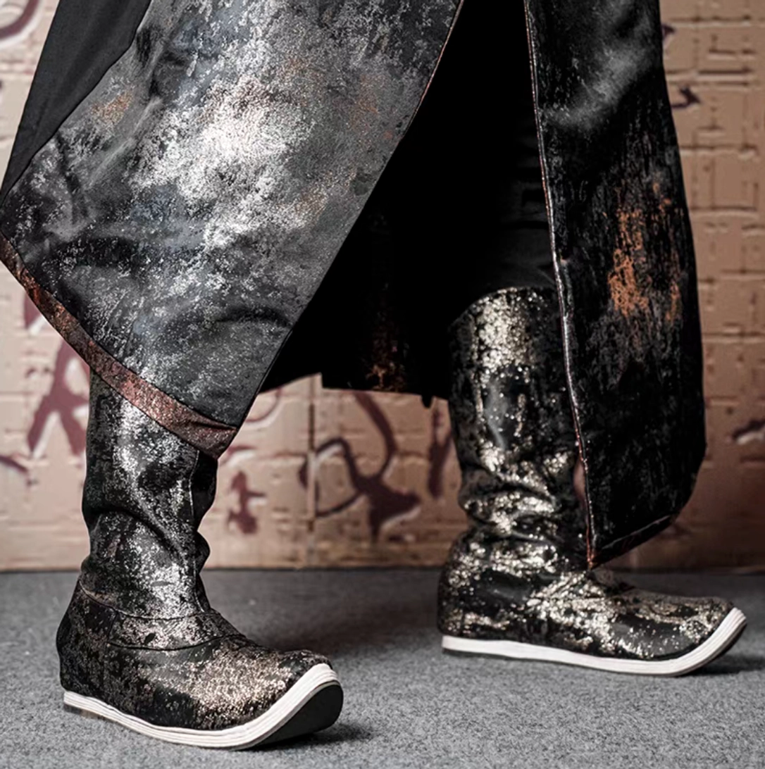 Pair of men's traditional Chinese Hanfu dragon scale boots worn with a long robe, featuring matching metallic scale texture, bronze robe trim, and clean white rubber midsoles