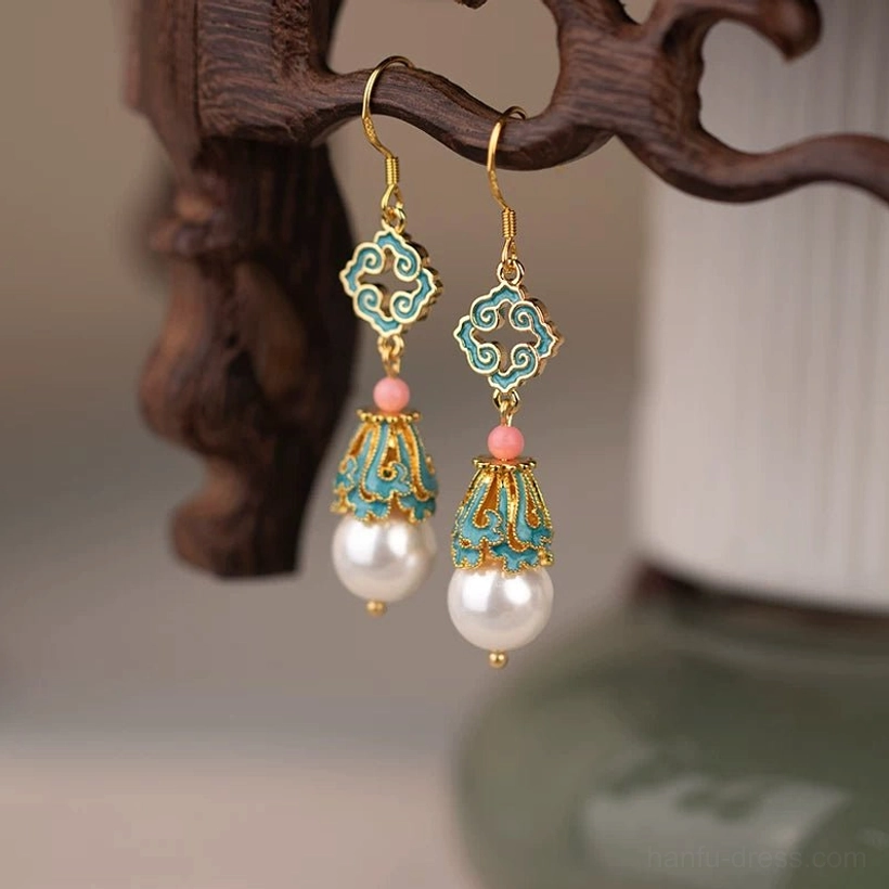 Side view of classical Chinese cloud earrings with blue pink gold and white pearl details displayed on a wooden jewelry stand