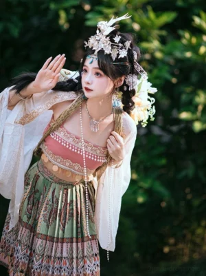 Three quarter view of a Miao inspired Hanfu clothing set with flowing chiffon sleeves gold waist accents patterned pleated skirt and layered pearl necklace