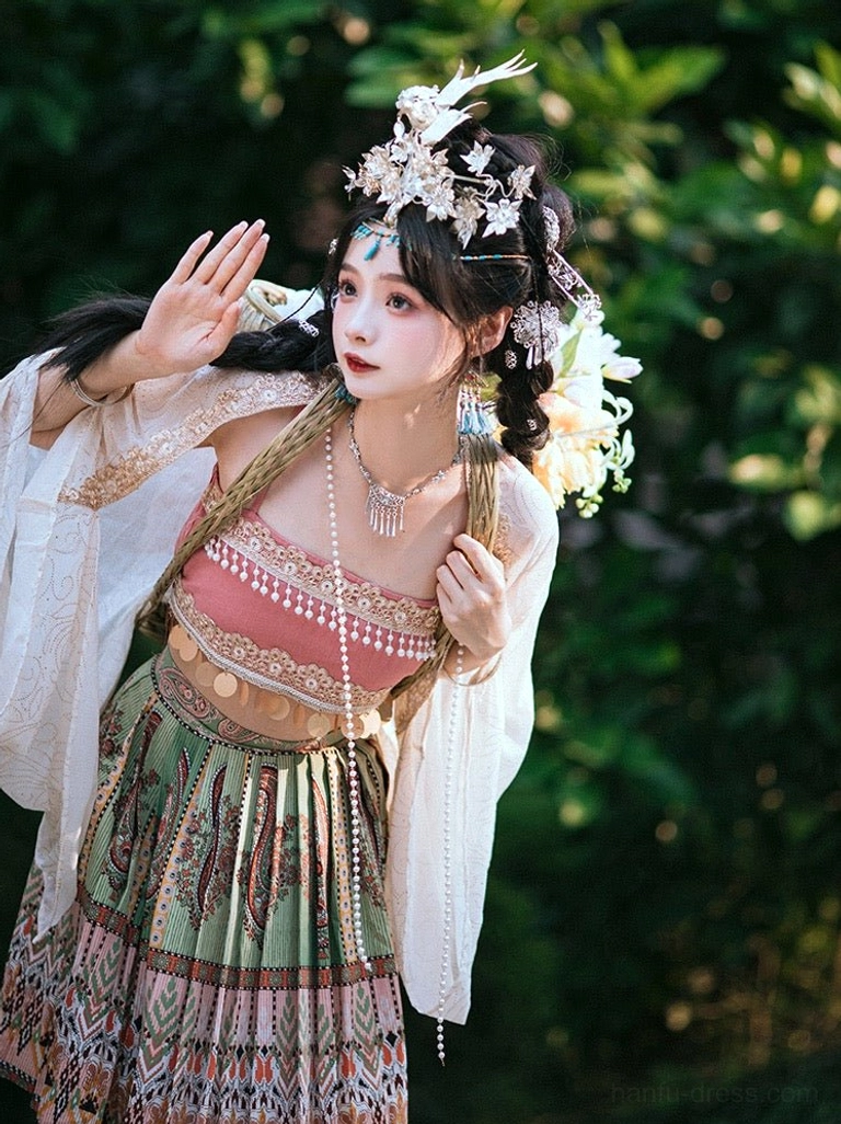 Three quarter view of a Miao inspired Hanfu clothing set with flowing chiffon sleeves gold waist accents patterned pleated skirt and layered pearl necklace