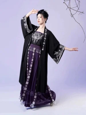 Complete Miao-inspired modern Hanfu set with black embroidered cardigan, purple pleated skirt, silver embroidery, tassels, and traditional hairstyle
