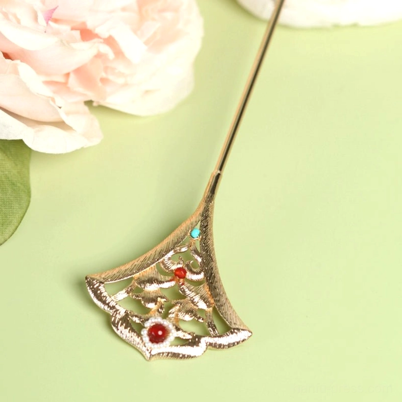 Side close-up of a Miaoling gold ginkgo leaf hair pin showing delicate hollow metal carving, smooth brushed texture, red and turquoise beads, and pearl accents