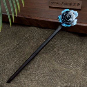 Midnight blue and white rose Chinese hair stick with matte black wooden pin displayed on a vintage wooden tray for Hanfu hairstyles