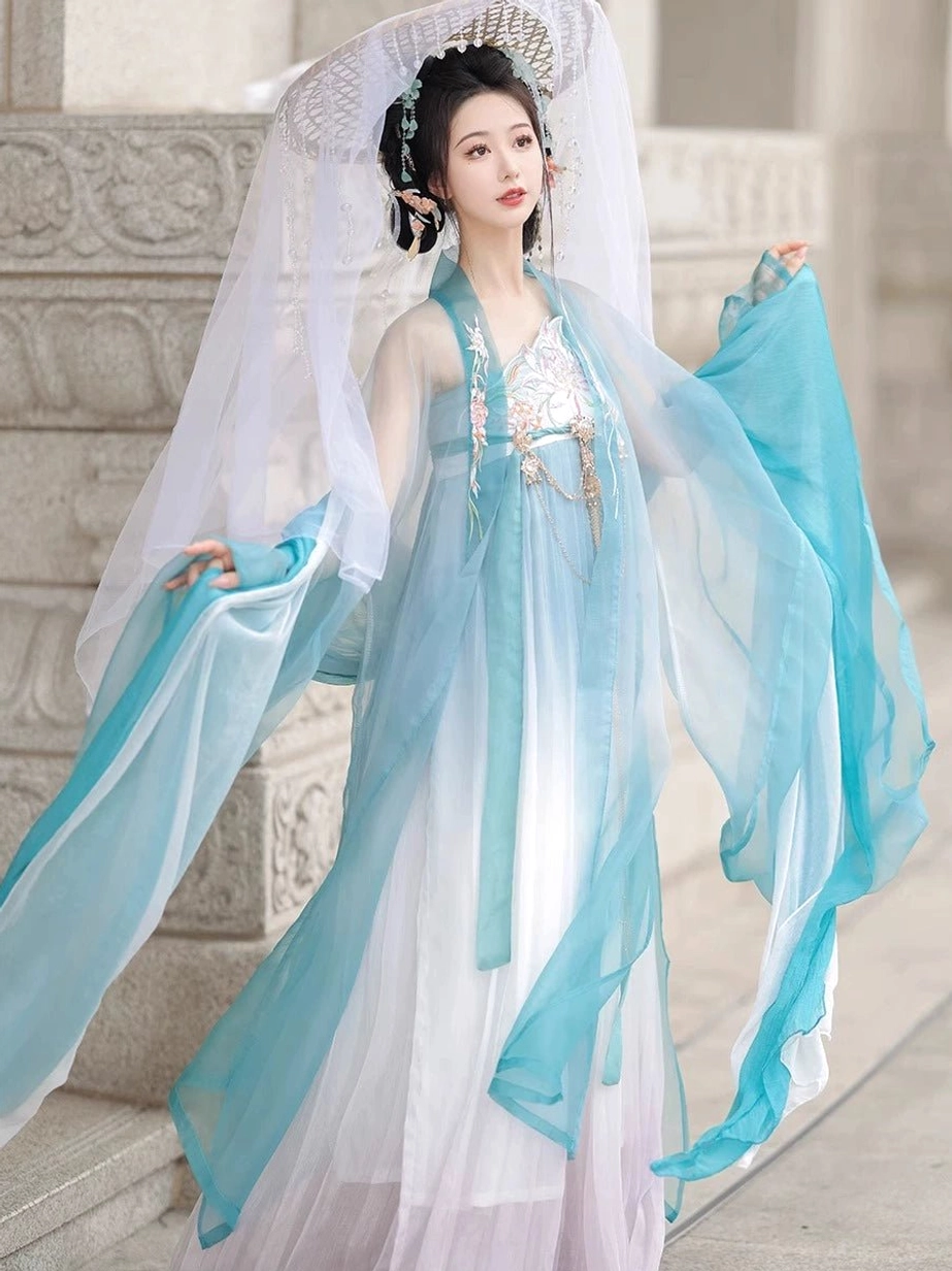 Blue gradient Tang style Hanfu Heziqun featuring oversized sheer sleeves, embroidered floral chest panel, tassel details and long skirt