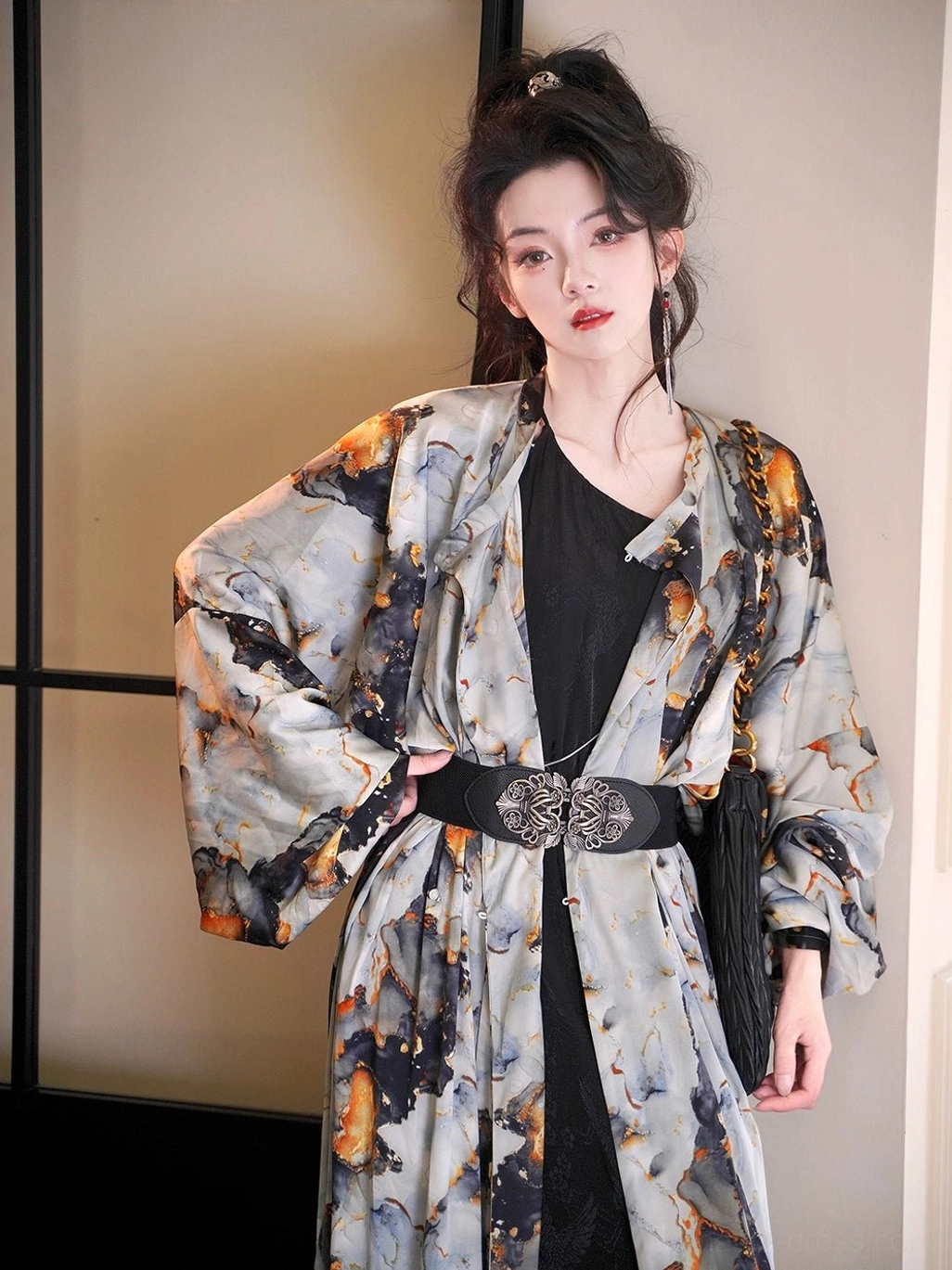 Front detail view of the Tang dynasty inspired round neck Hanfu robe layered over black clothing with loose sleeves and ink-wash print