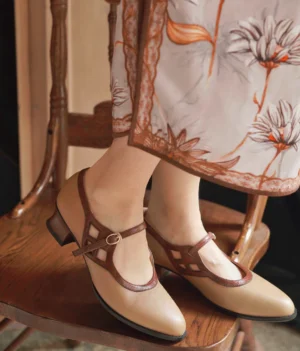 Milk tea vintage qipao Mary Jane heels worn with a floral cheongsam, showing the two-tone brown canvas upper, T-strap ankle buckle, pointed toe, and low block heel