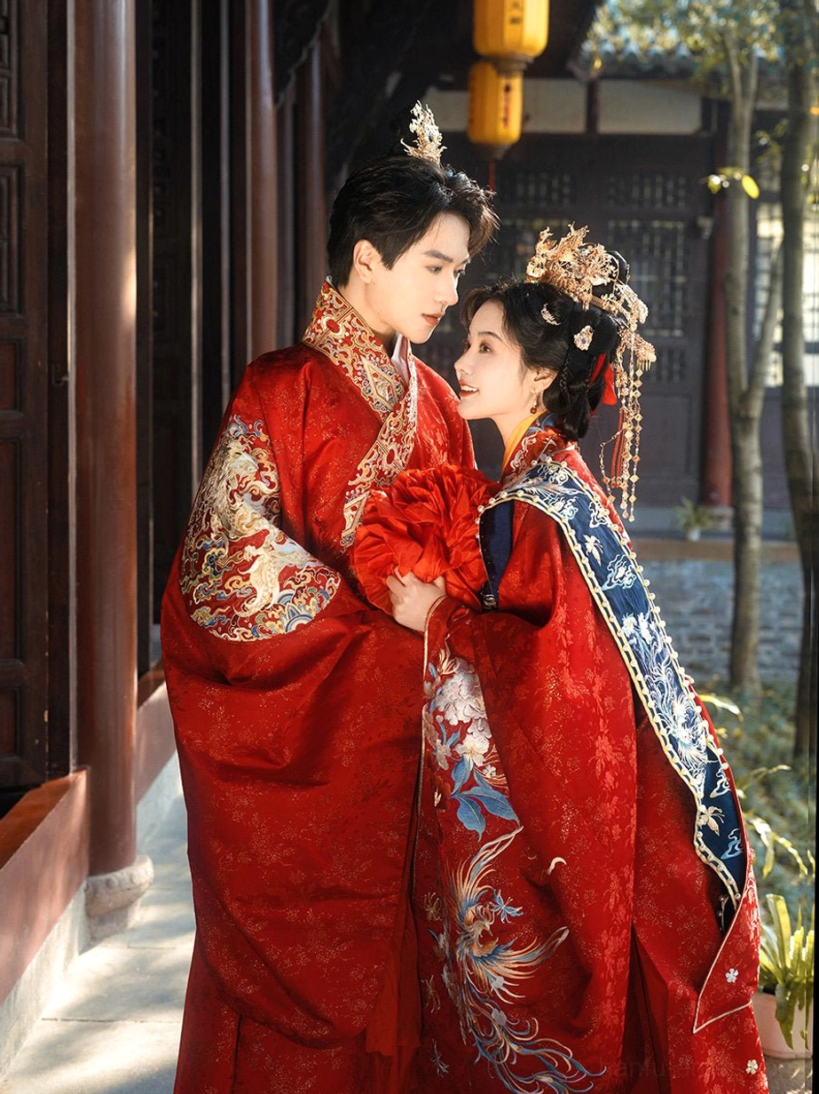 Close-up front view of a couple in traditional Ming Dynasty Chinese wedding Hanfu, featuring a dragon embroidered groom robe, phoenix shoulder cape, ornate bridal headpiece, and red silk wedding bouquet