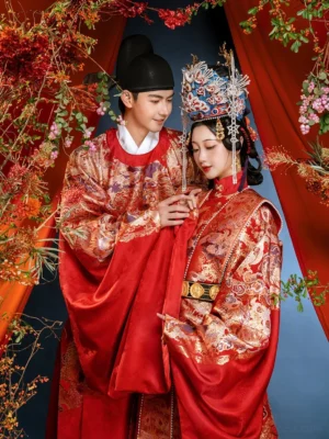 Traditional Chinese Ming Dynasty wedding Hanfu couple wearing matching red and gold ceremonial robes with formal groom hat