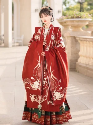 Front view of a complete Ming Dynasty Chinese wedding Hanfu outfit with red embroidered robe, flowing sleeves, pleated Mamian skirt, green trim, and bridal hair jewelry