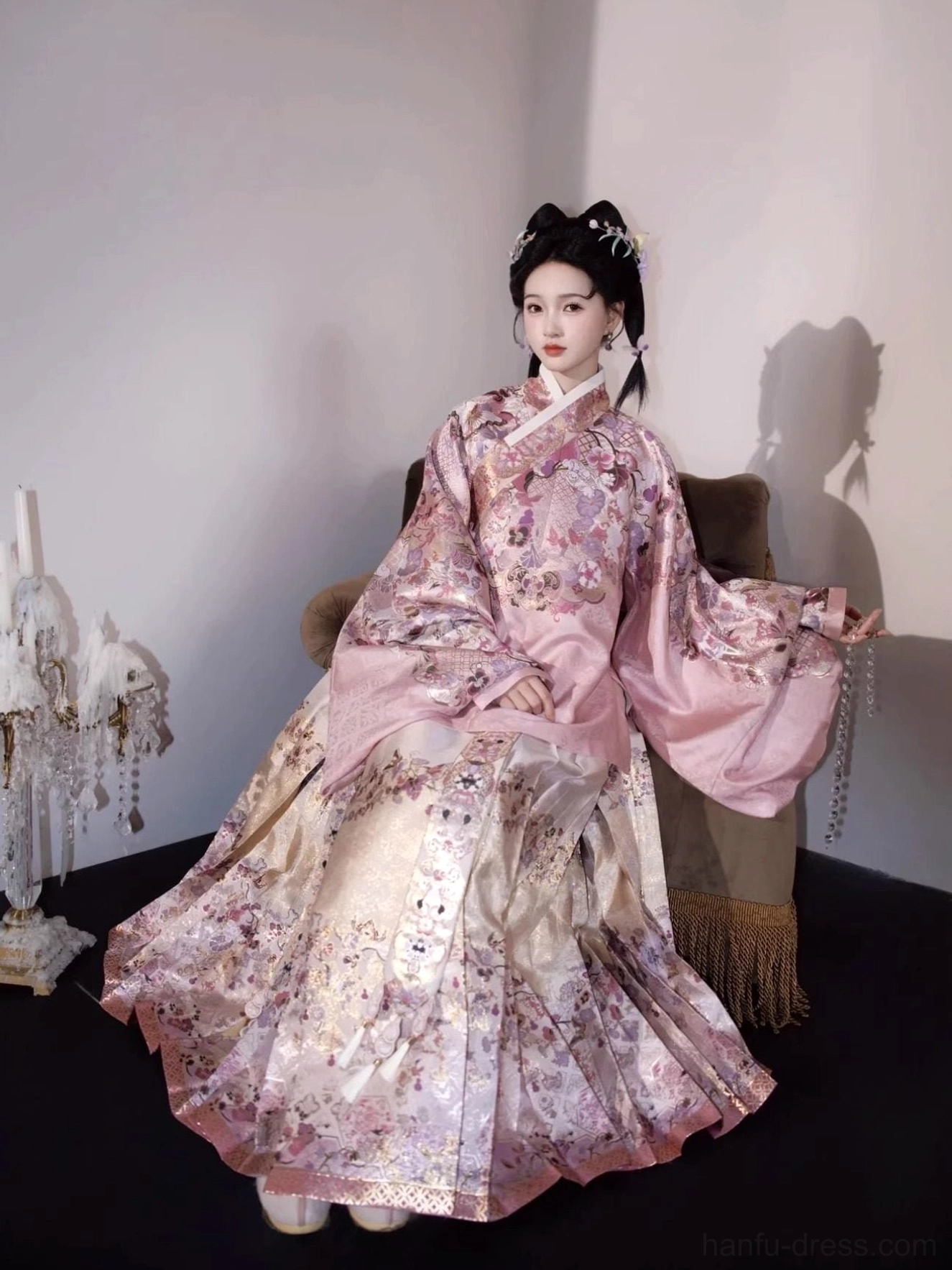 Side seated view of a floral Ming Dynasty hanfu set with oversized pipa sleeves and matching full-length mamian skirt