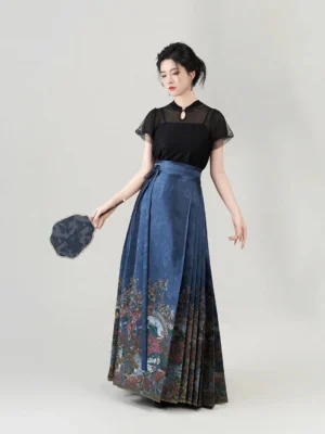 Full-length three-quarter view of a Ming Dynasty-inspired Hanfu outfit with a black sheer-sleeve blouse, navy floral mamian skirt, and round silk fan