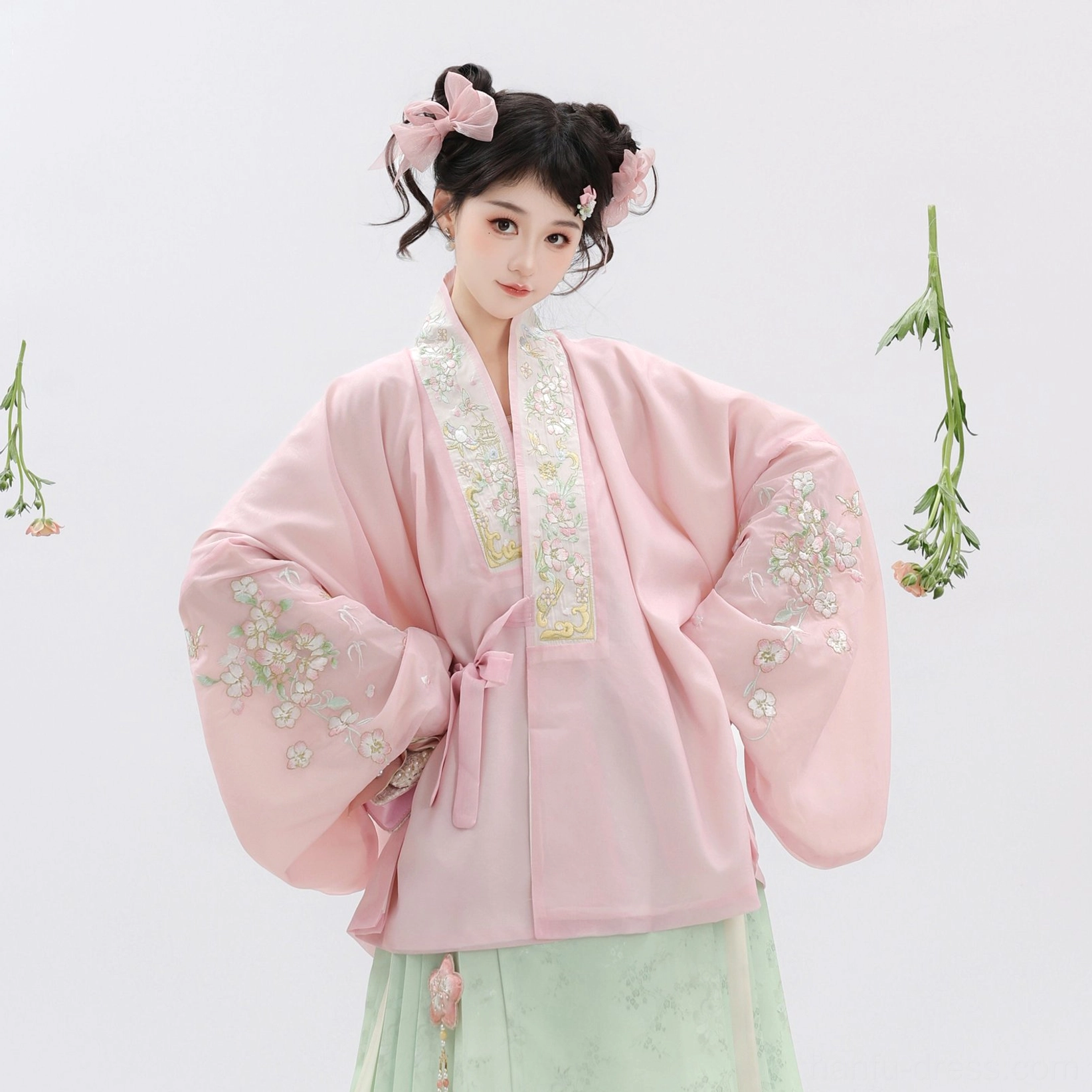 Close-up of pastel pink Ming Dynasty Hanfu cross-collar top with floral embroidery wide sleeves and delicate neckline trim
