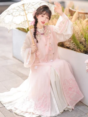 Pink and green Ming Dynasty hanfu floral vest with beige robe, modern Chinese two piece outfit with layered sleeves, flower embellishments, and elegant traditional styling