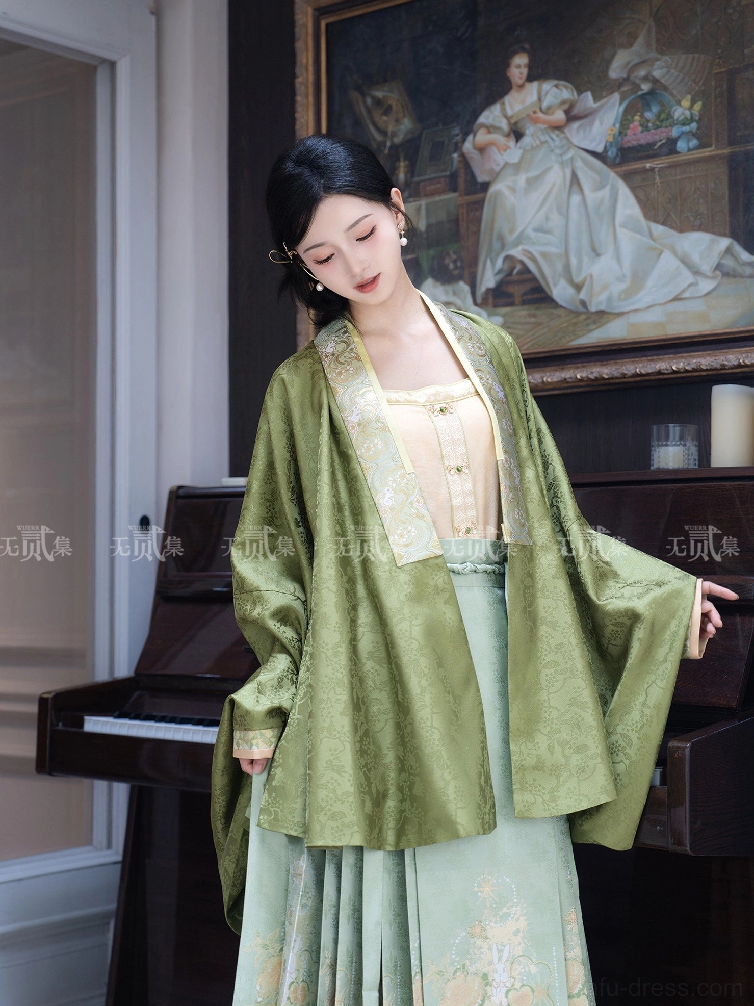 Close front view of Ming Dynasty Hanfu olive green jacquard cardigan and camisole beside a classical piano highlighting the textured fabric and collar trim