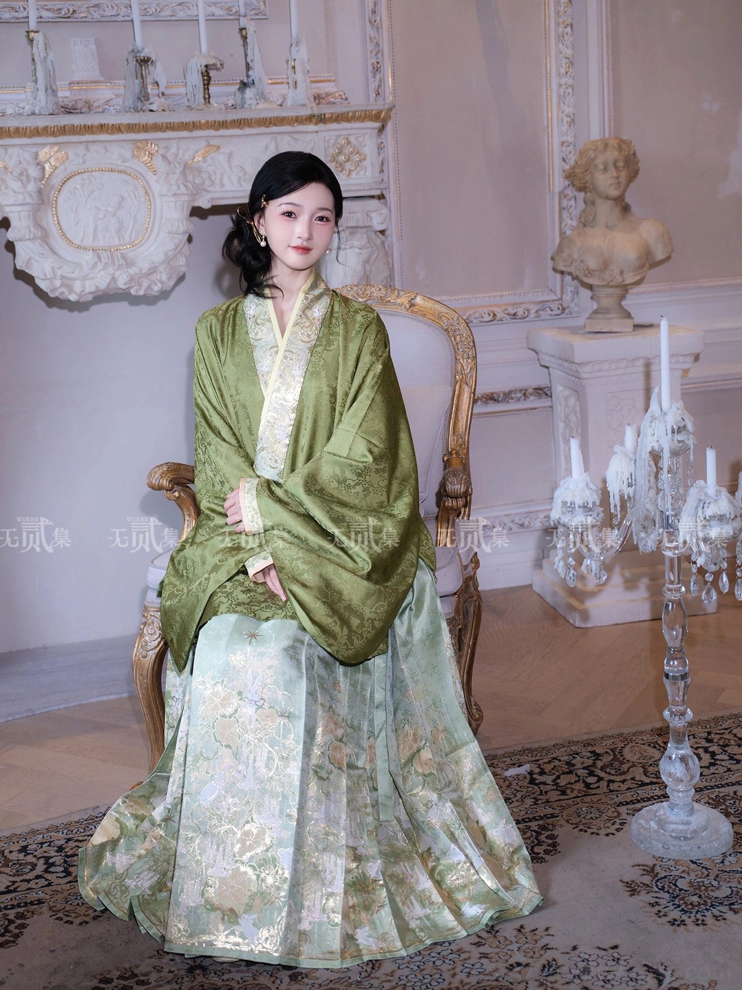 Seated side view of a traditional Chinese Ming Dynasty Hanfu set with clearly visible pleats and patterned jade green mamianqun skirt