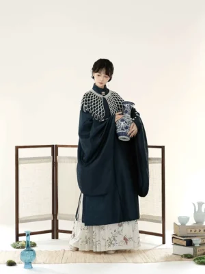 Dark navy Ming Dynasty Hanfu set with long stand collar robe, white floral embroidered Mamianqun skirt, patterned cloud collar, and traditional Chinese studio styling
