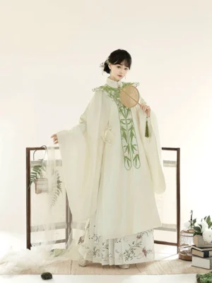 Off-white Ming Dynasty Hanfu robe and floral Mamianqun skirt with bamboo embroidered collar, traditional updo, and wooden tassel fan