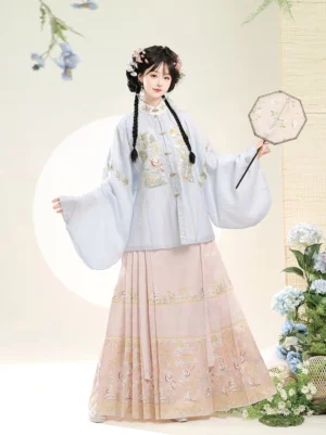 Front full-body view of a Ming Dynasty hanfu set with light blue embroidered pipa sleeve top, pink mamian skirt, osmanthus rabbit motifs, and golden decorative trim