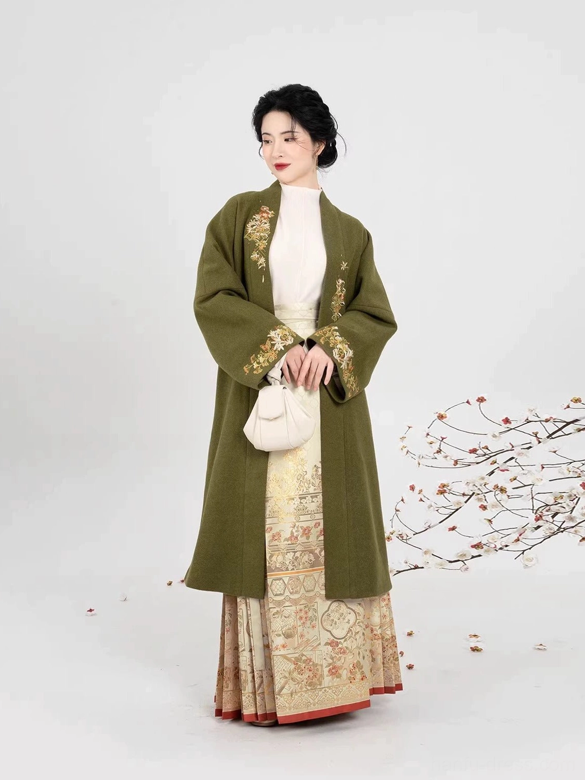 Ming Dynasty-inspired Chinese hanfu outfit with olive-green floral embroidered coat, patterned mamian skirt, and retro hairstyle