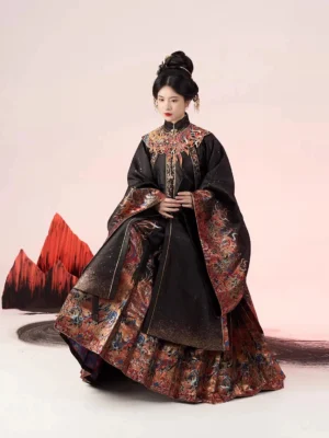 Full Ming Dynasty Hanfu set in black and crimson brocade shown in a three-quarter seated studio view with wide sleeves, ornate trims, and red mountain-inspired decorative props
