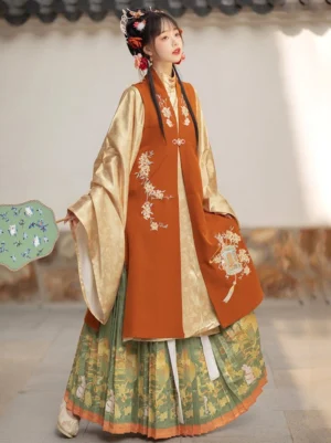 Ming Dynasty hanfu woman wearing a terracotta embroidered bijia vest, cream wide-sleeve robe, and green pleated mamian-style skirt in a traditional Chinese courtyard