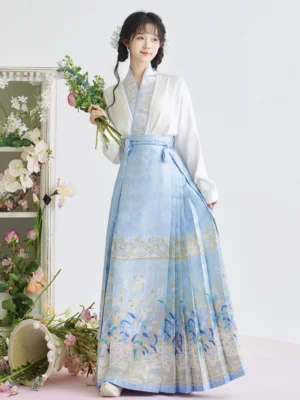 Three-quarter front view of white cross-collar Ming-style Hanfu top with gradient blue iris print mamian skirt