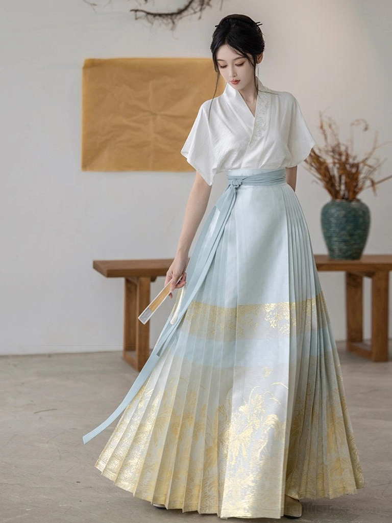 Front view of modern Ming Dynasty Hanfu with white flare sleeve top and light blue pleated mamianqun skirt